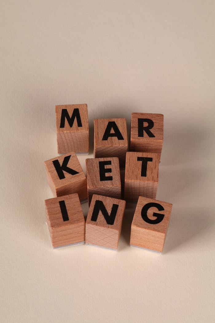 Wooden blocks arranged to spell MARKETING on a neutral background.